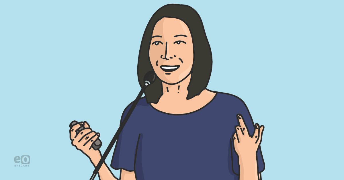 Image of the author giving a presentation by speaking into a microphone and holding a remote.